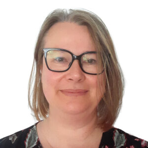 A headshot of a woman with shoulder-length light brown hair, wearing black-framed glasses and a dark patterned top against a white background.