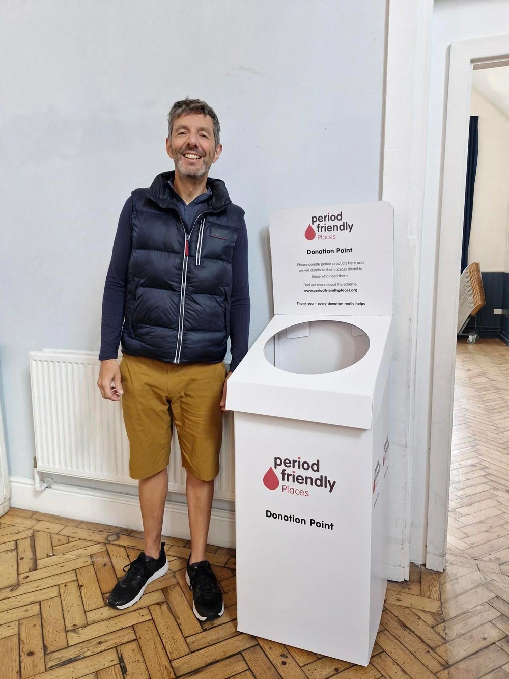man standing period friendly places donation bin