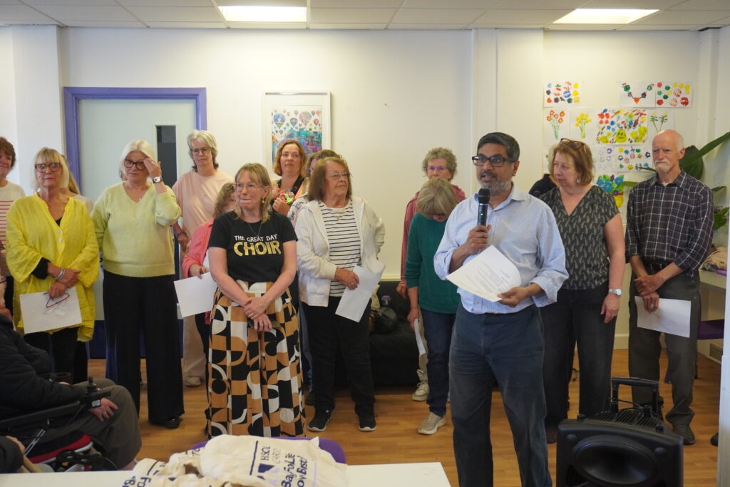 Samir Savant from SGB introduces choir. Credit Strike. DSC00552